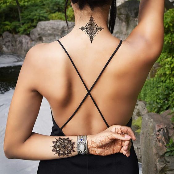 Back tattoos of a woman; Ribbon tattoos; Flower tattoos; Cross tattoos; Little prince tattoos; Symbol tattoo; Pattern tattoos; Back tattoos